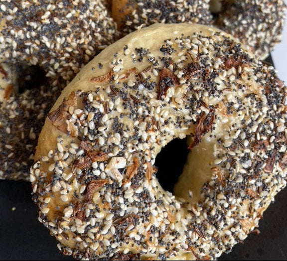 Bagels with sesame seeds and poppy seeds on a white plate